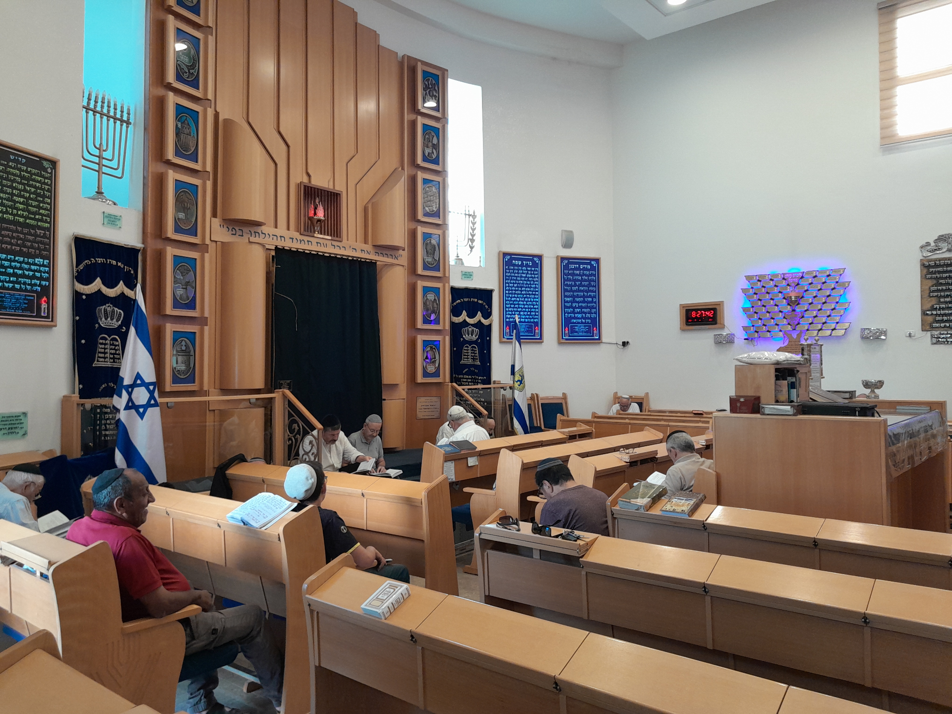 Worshipers seated low to the ground in a Jerusalem synagogue on Tisha B'Av morning